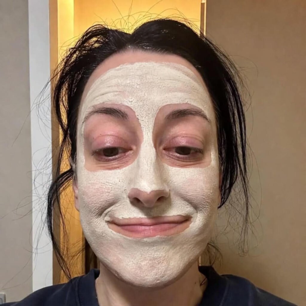 Cluttered coffee table with journal, cold matcha, tangled headphones.